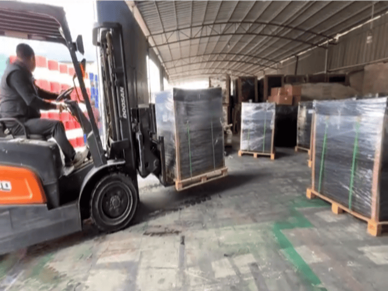 Using a heavy flooring roller on a fresh rubber installation